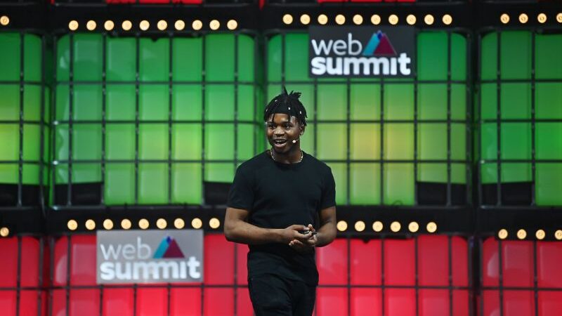 Andrew Ologunebi a Black man wearing a black top and pants speaking at Web Summit