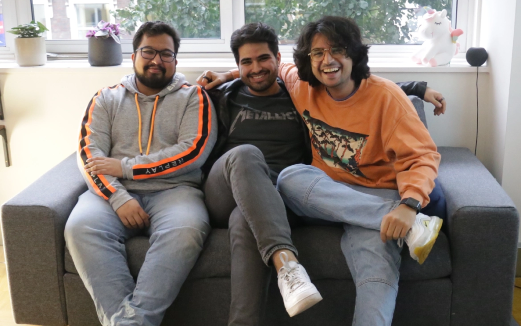 Ali Attar, Mahyad Ghassemibouyaghchi, Saurav Mitra, three Asian men sitting on a sofa, smiling at the camera.