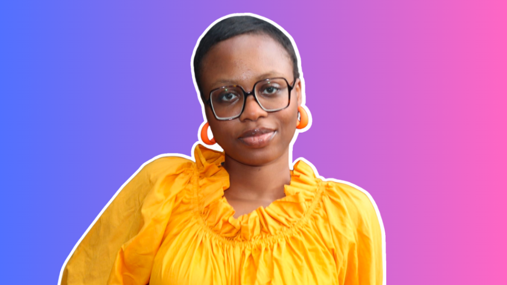 Ifeoma Igwe, a Black woman with short hair and glasses wearing and yellow top